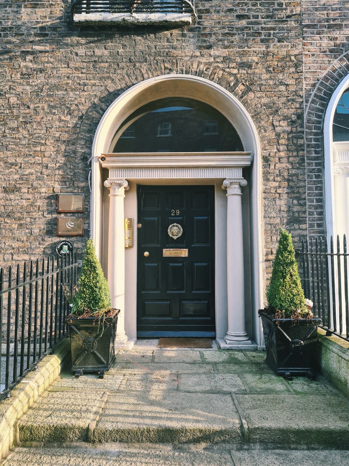 Contact A Georgian doorway with a fanlight arch in a Dublin brick facade