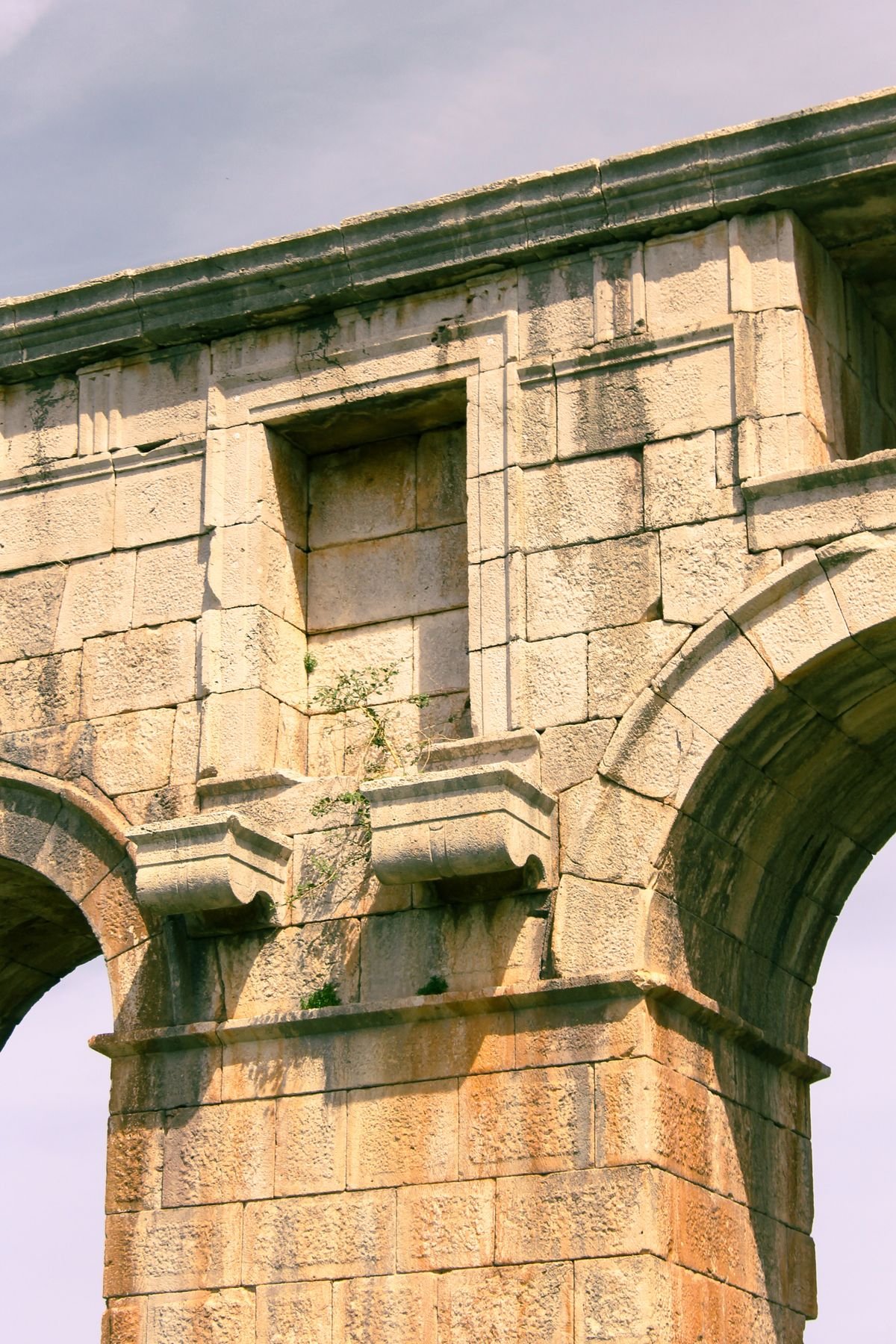 Home Weathered stone arches in a masonry wall